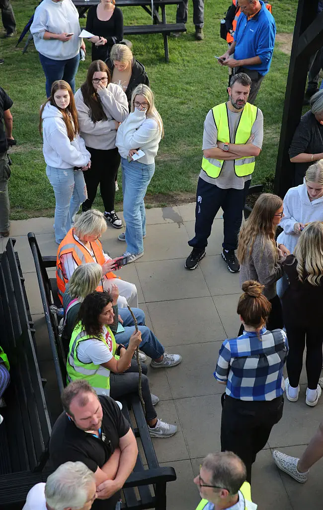 Volunteers reacting to the news yesterday that a body had been found (Martin Pope/Getty Images)