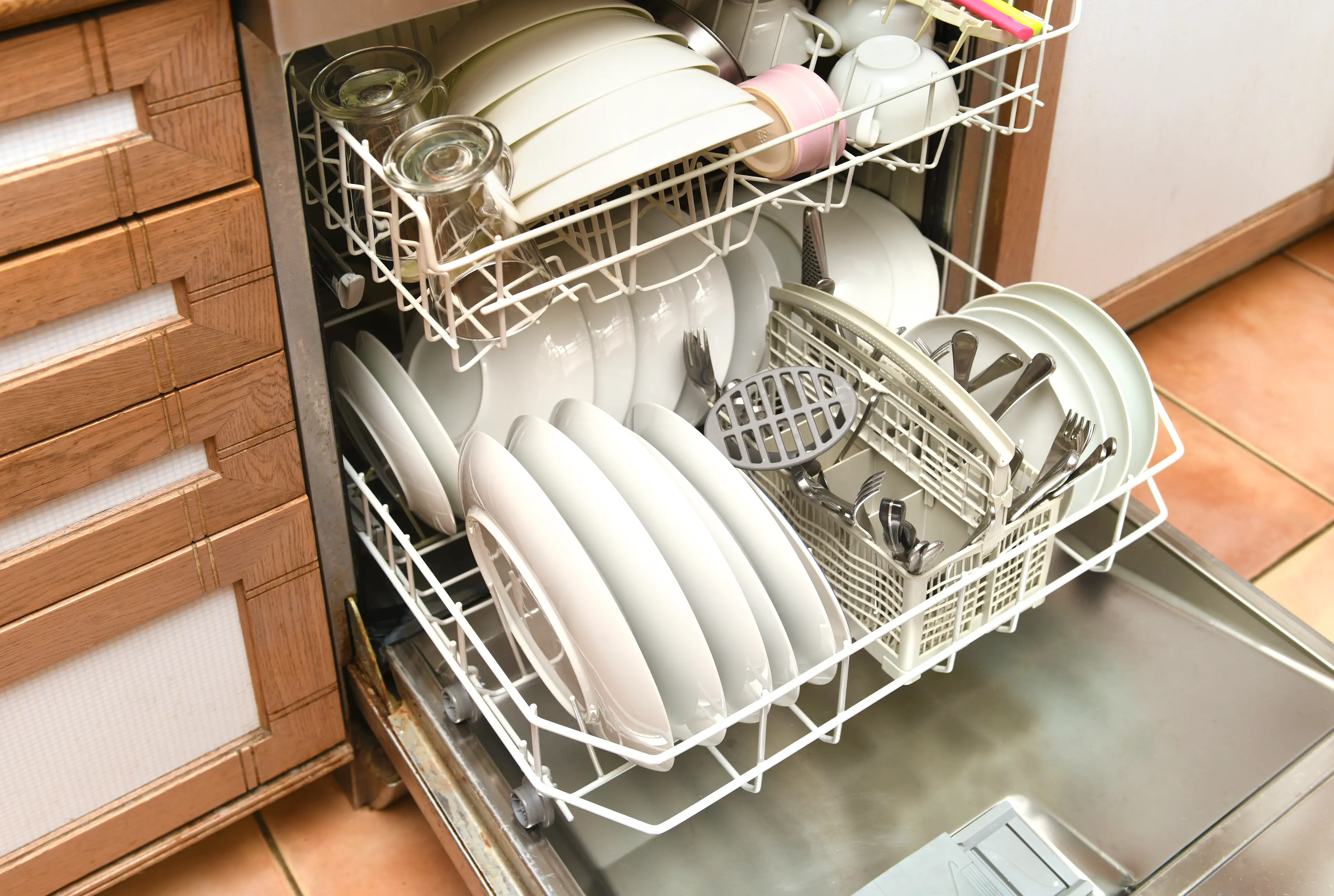 Apparently, we shouldn't be rinsing before stacking our dishwasher. (Peter Dazeley/Getty)