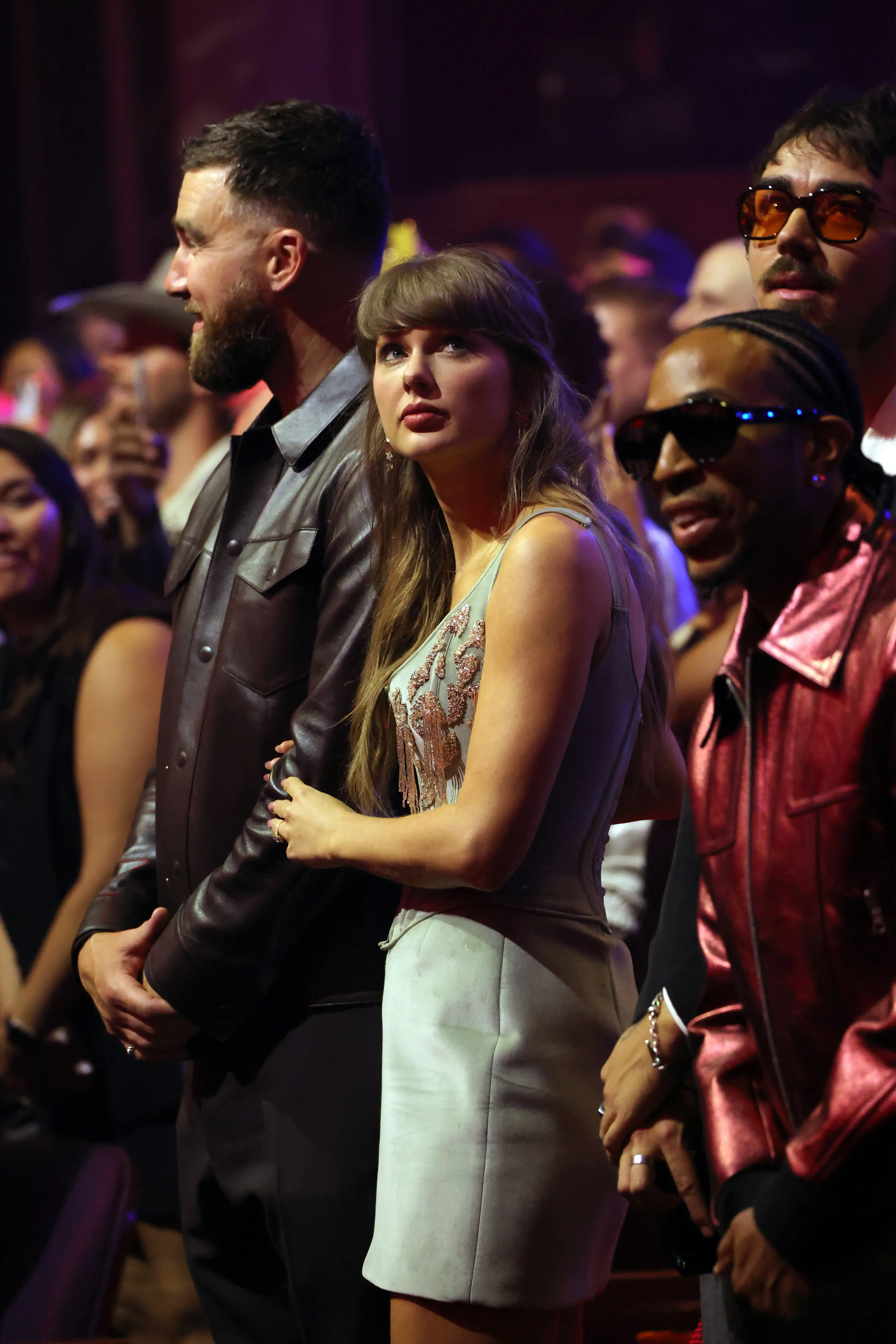 A lip reader has analysed an awards show moment between Taylor, Travis and Sombr (Kevin Mazur/Getty Images for iHeartRadio)