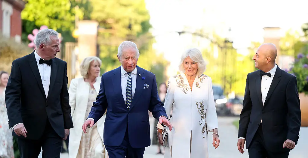 Annabel (back left) wore a long white coat with a matching white dress featuring gold motifs (CHRIS JACKSON / Contributor / Getty Images)