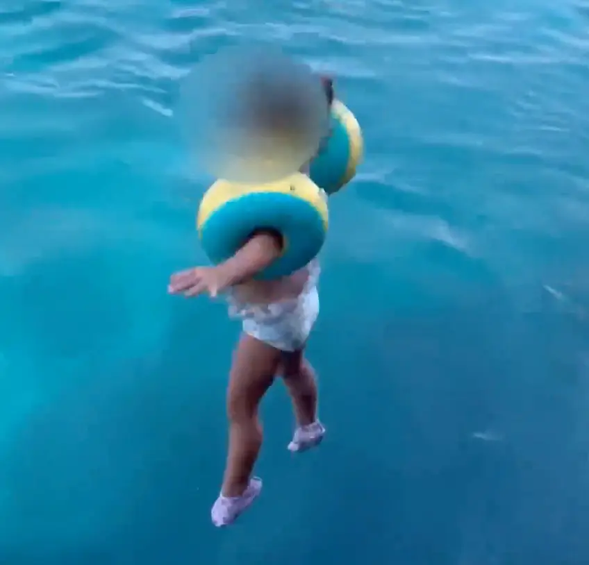 The young girl was happy to jump from the boat.