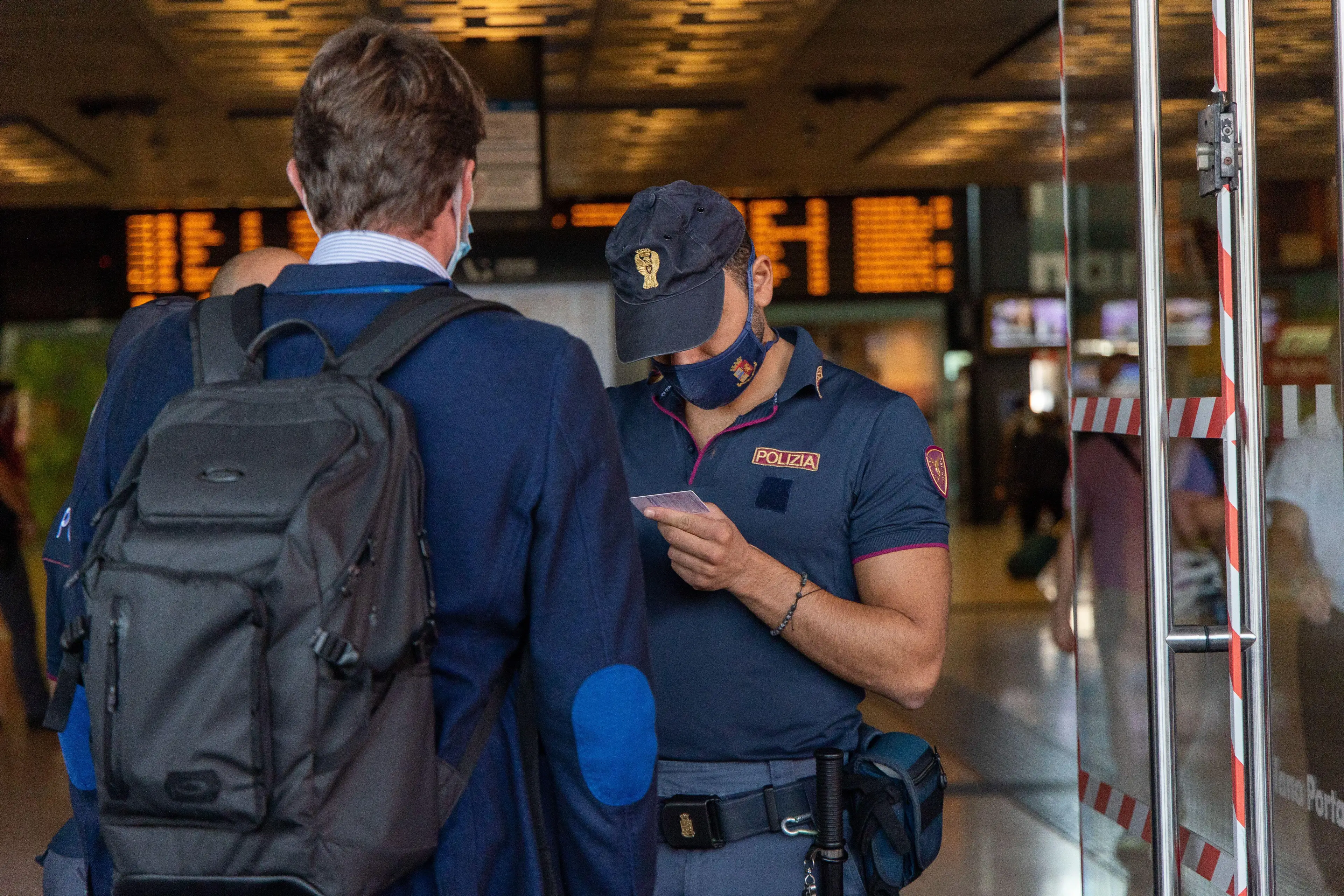 A man having his ID checked by Italian authorities.