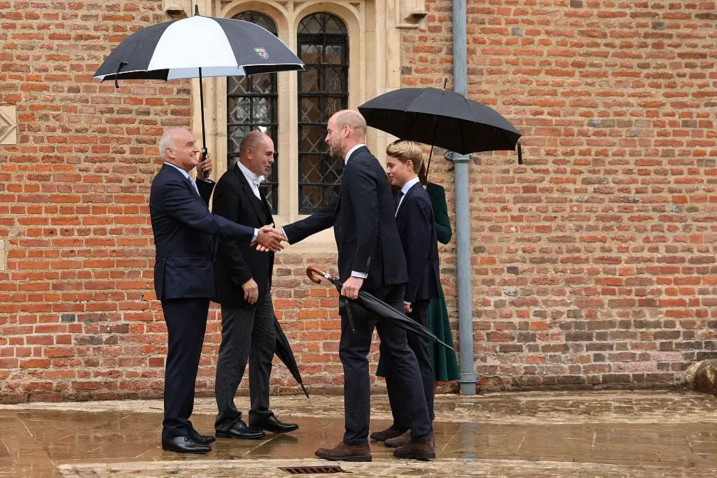Prince George was greeted by Eton headmaster Simon Henderson and provost Nicholas Coleridge (Adrian DENNIS / POOL / AFP via Getty Images)