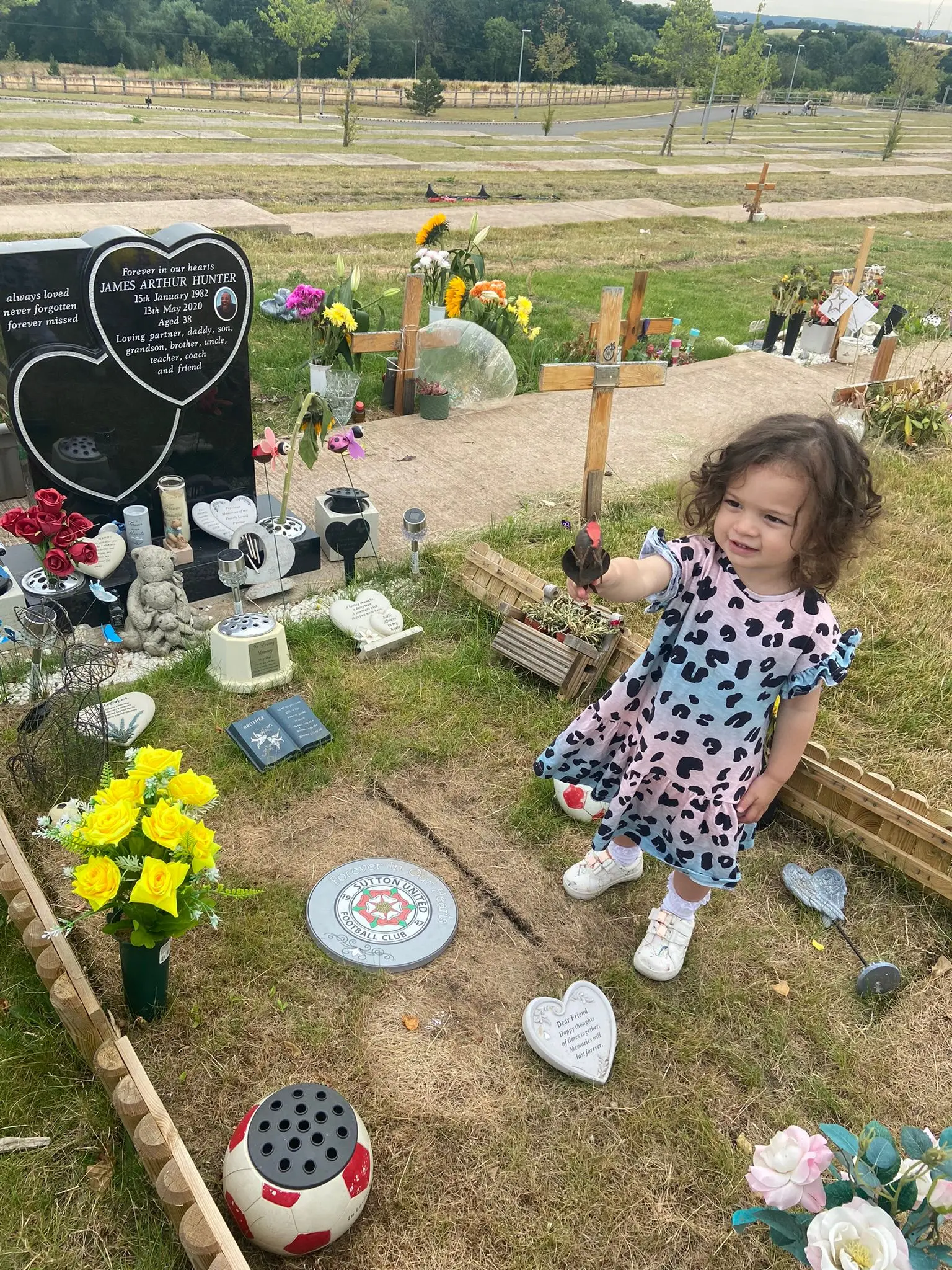Little Harper-May by her father's grave.