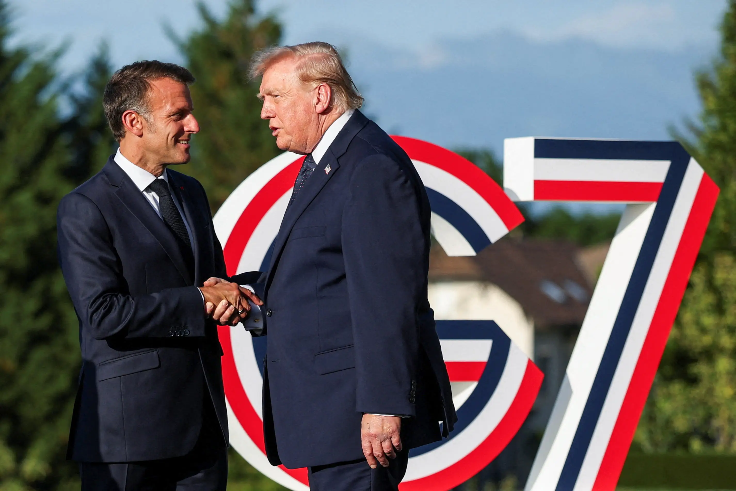 Trump enjoyed one of his signature 'tug of war' handshakes (Isabel Infantes / POOL / AFP via Getty Images)
