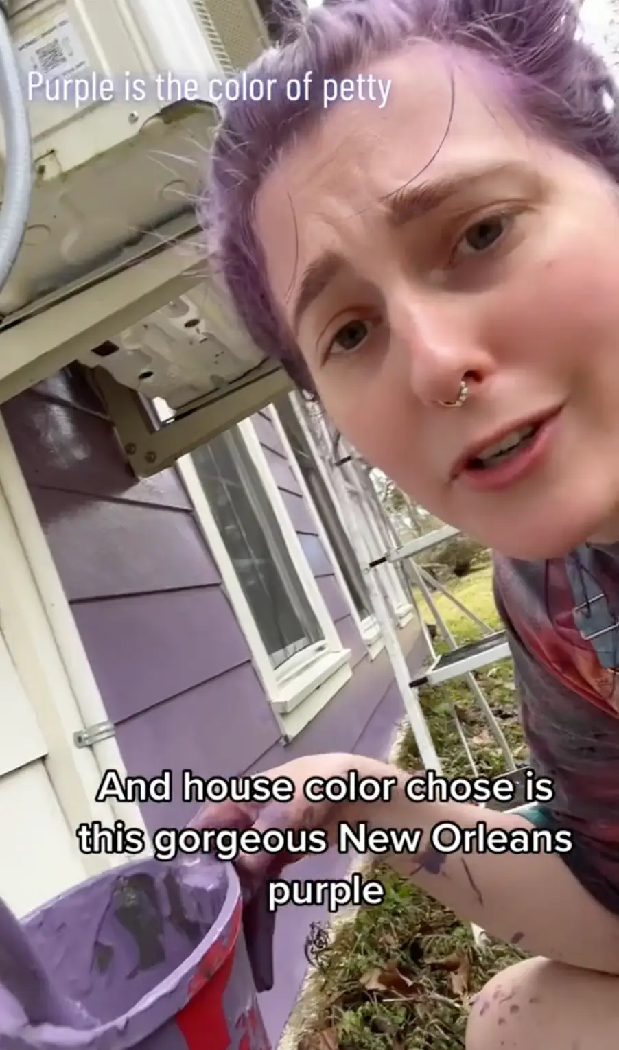 So, she's painting MORE purple onto the house.
