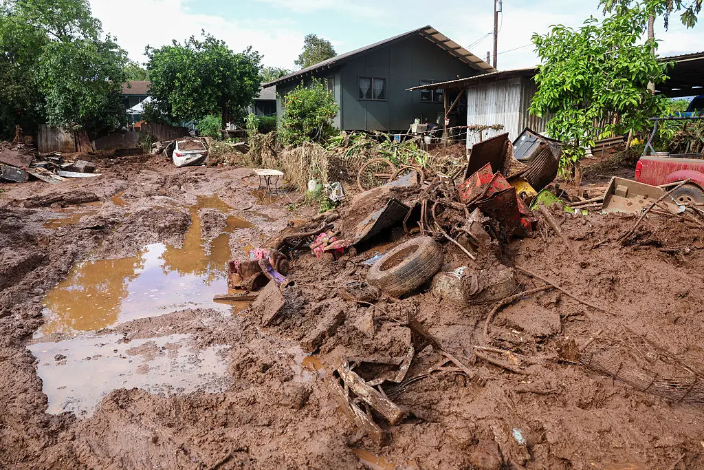 Thick mud and debris have been left behind following the flood waters (Photo by Marco GARCIA / AFP via Getty Images)