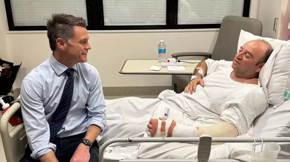 He rushed over to help Ahmed al-Ahmed, pictured here with NSW premier Chris Minns, but got severely injured in the process (Instagram/@chrisminnsmp)