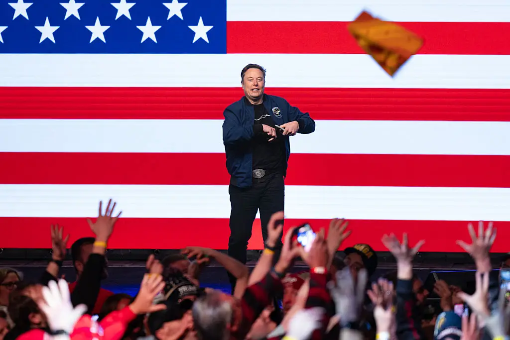 The multi-billionaire signed the headwear before throwing it into the crowd (Scott Olson / Staff / Getty Images)