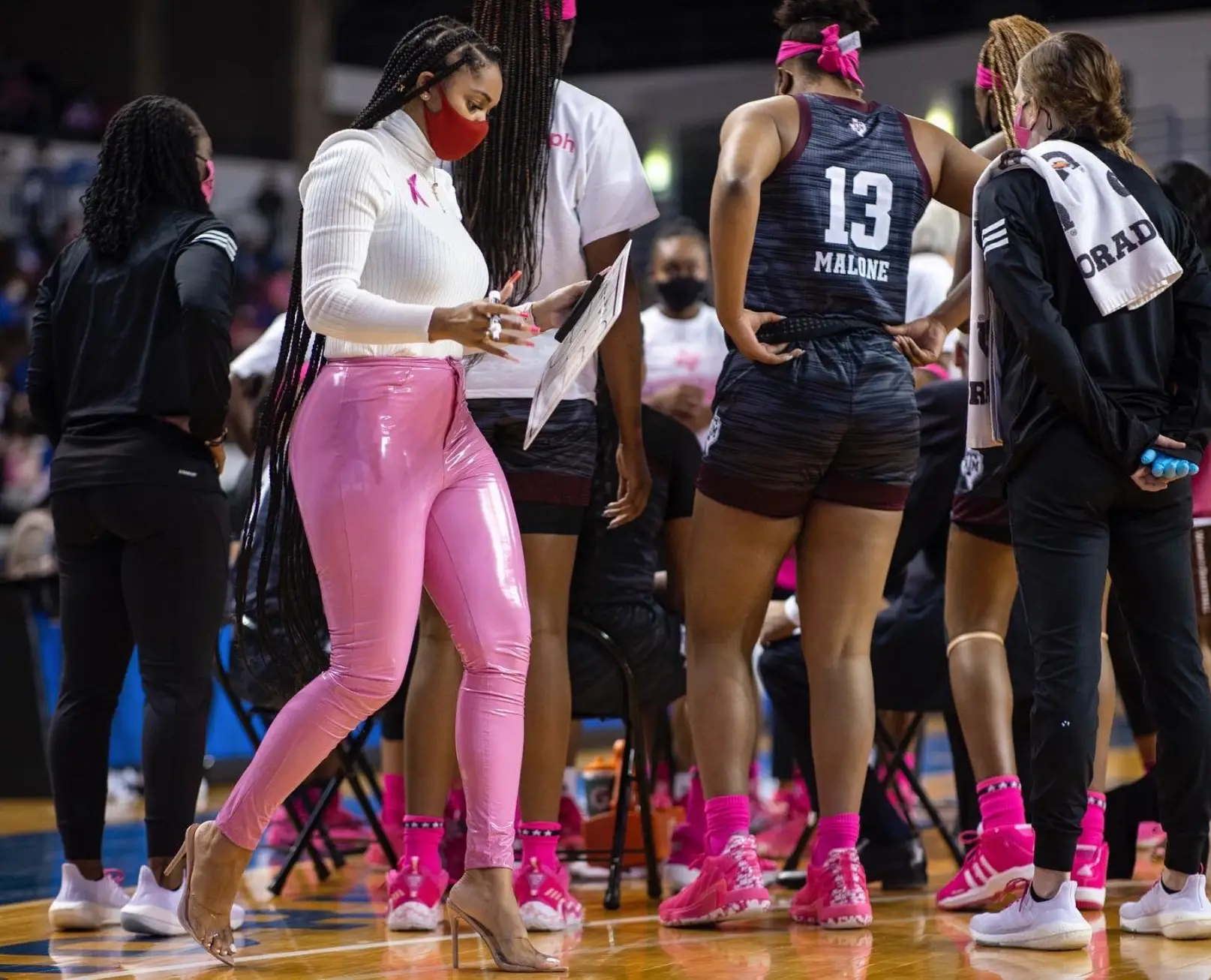 Sydney wore a turtleneck and pink trousers (