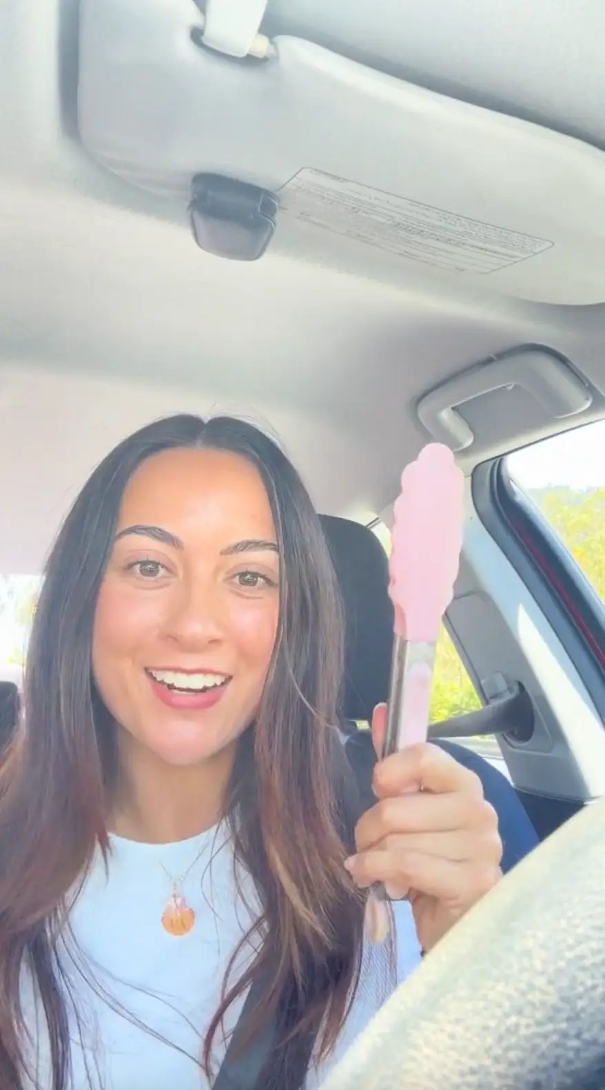 She uses the tongs to reach for ticket machines.