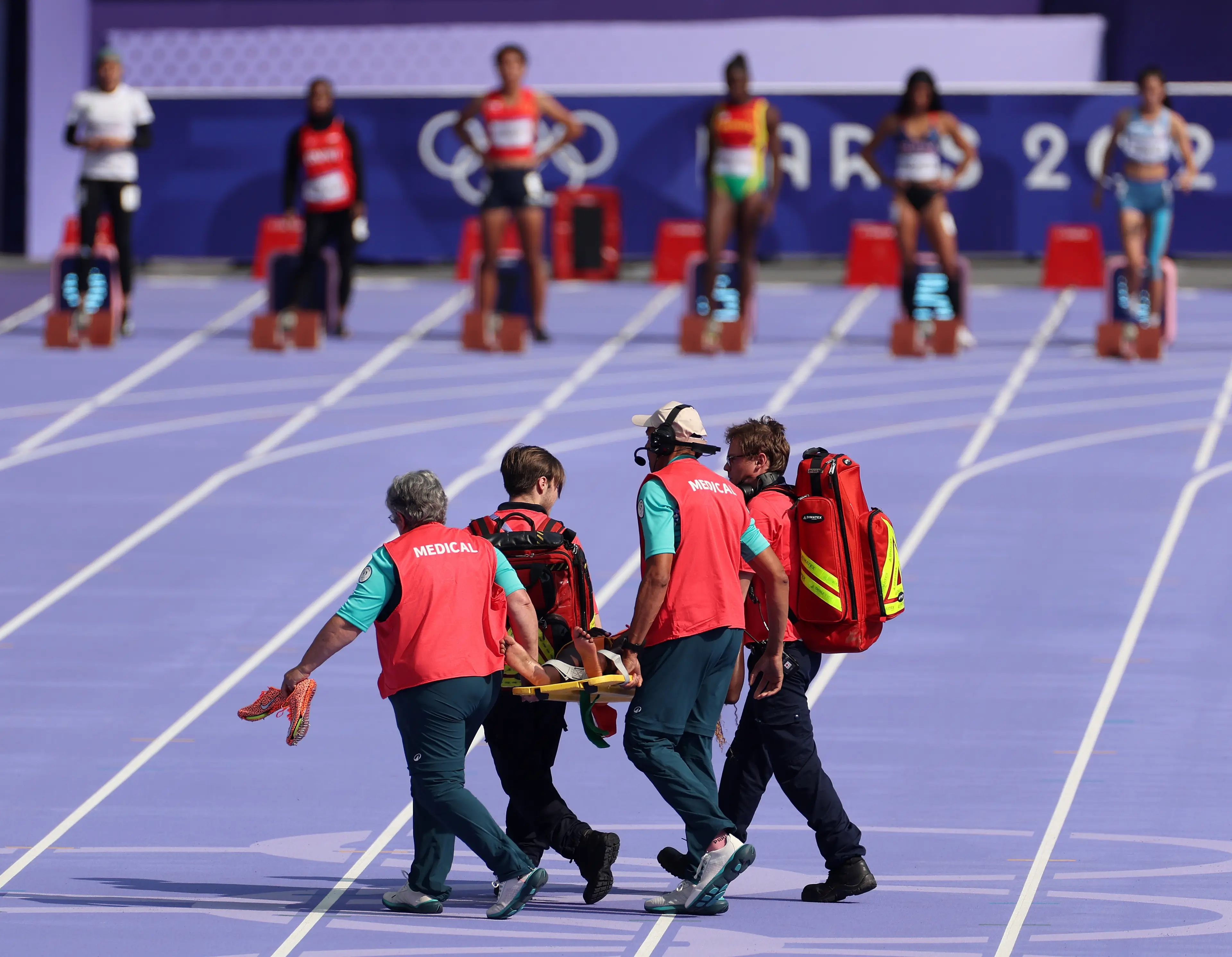 The runner was carried off the track. (Steph Chambers/Getty Images)