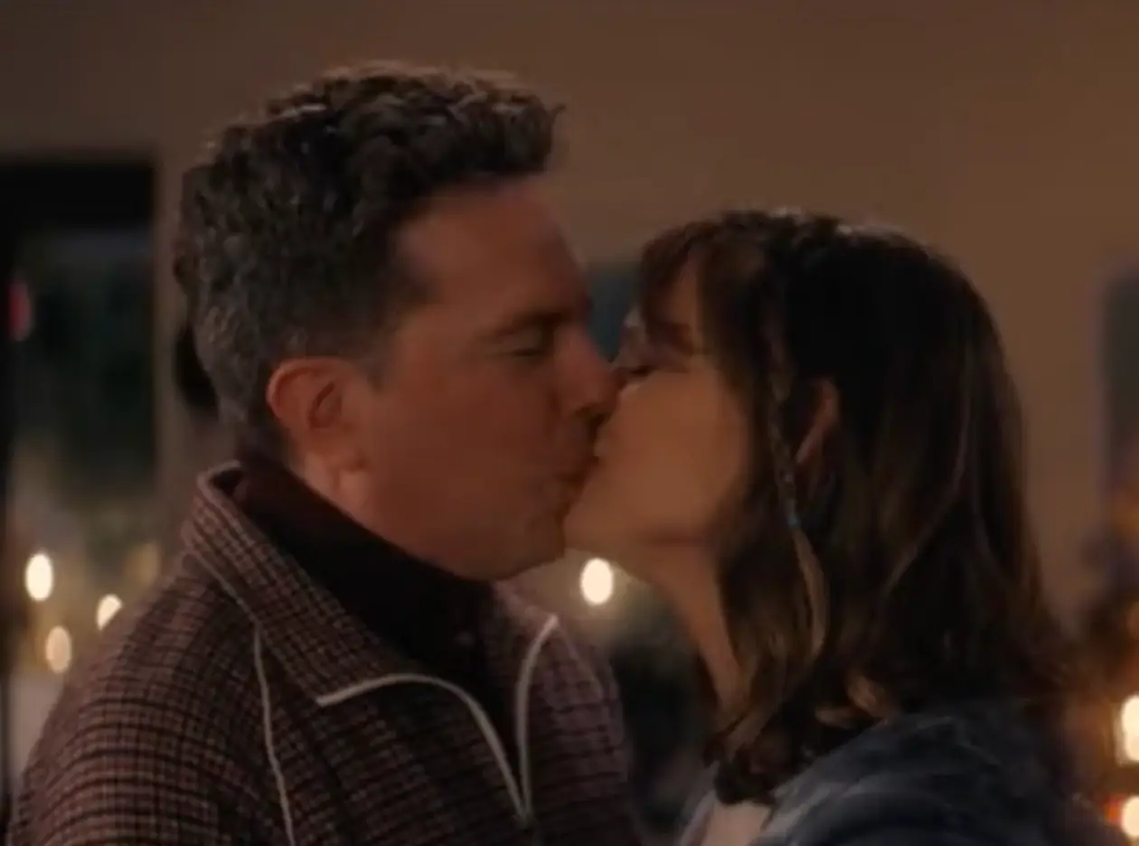 Two kids, in their parents’ bodies, are forced to kiss in front of their mum’s friends.