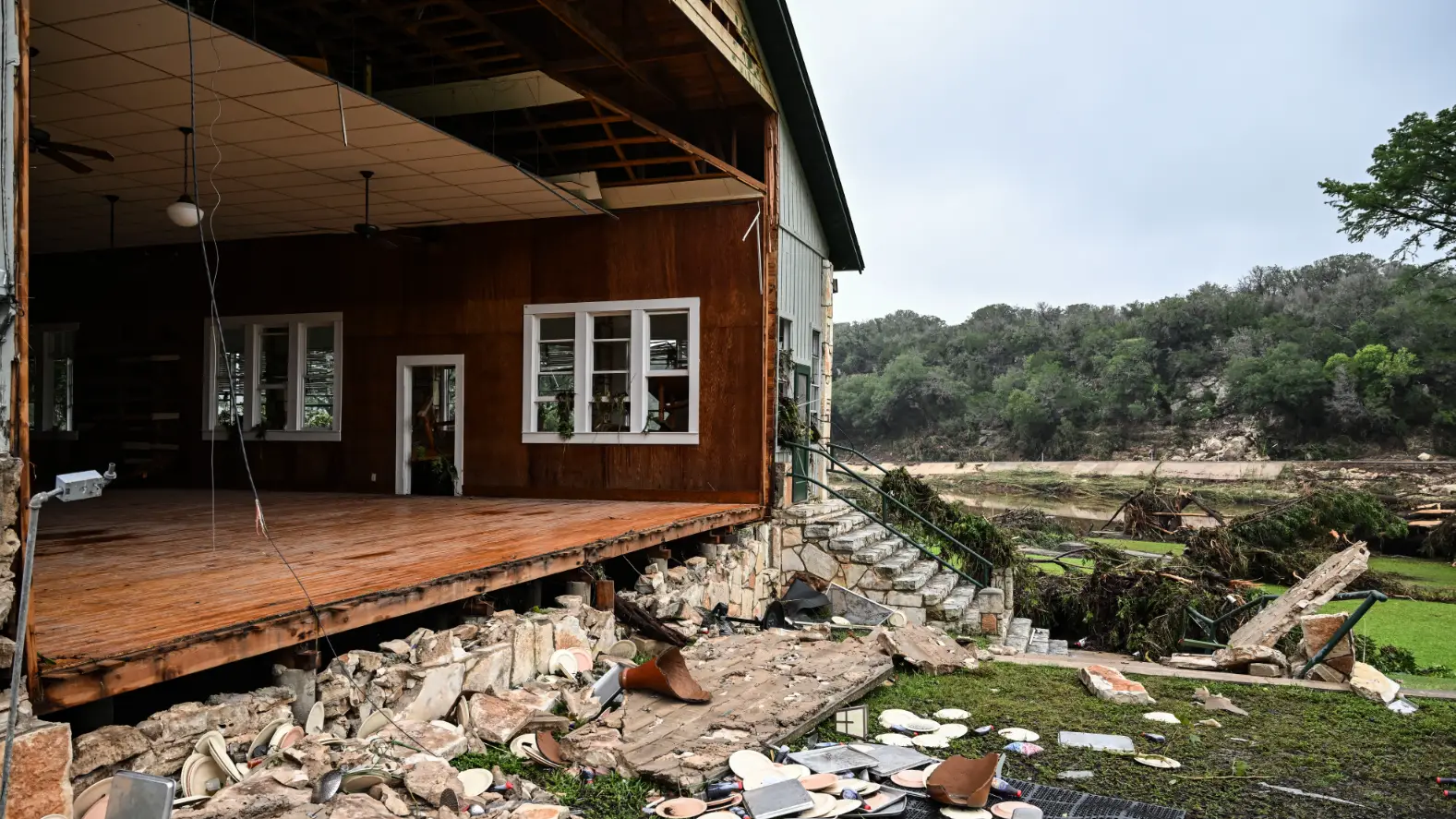 Camp director killed during devastating floods whilst trying to save girls as at least 26 others dead