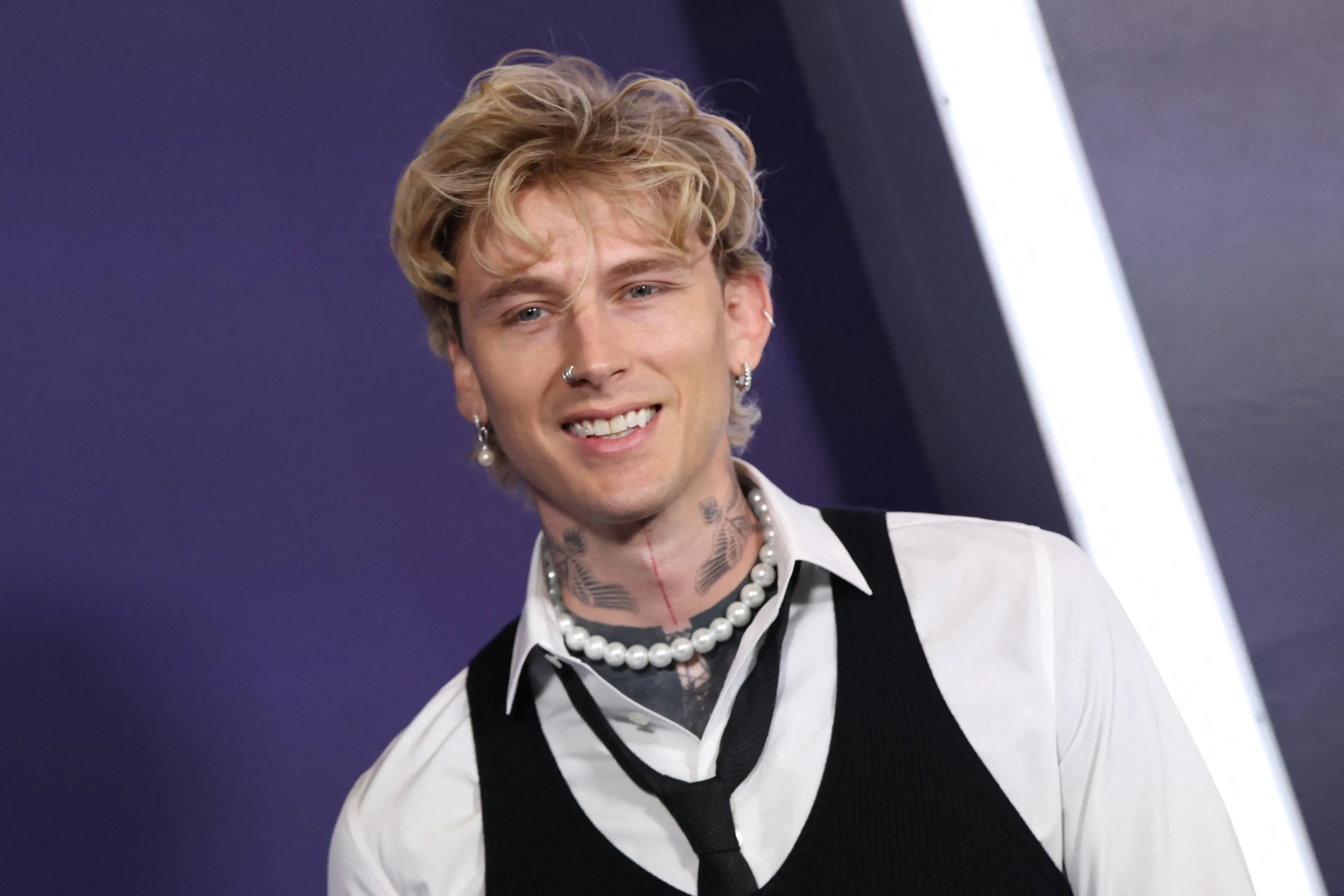 A much more clean-cut version of MGK, pictured at the 2025 AMAs, now shows up (MICHAEL TRAN/AFP via Getty Images)