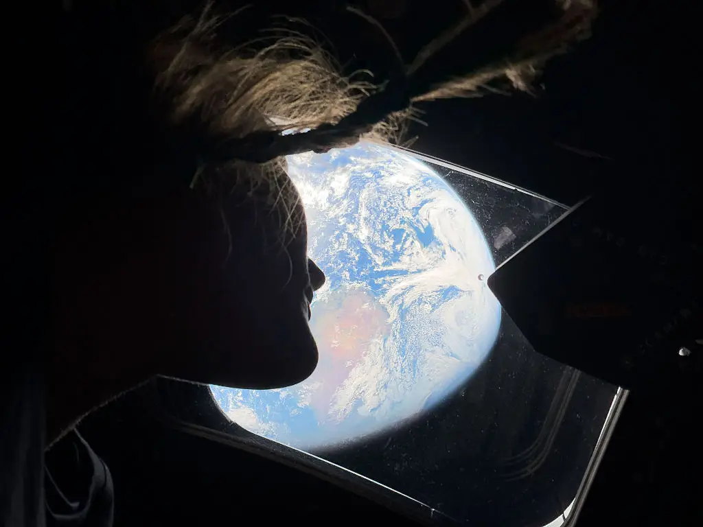 Christina Koch peers out of the window back to Earth from the Artemis II mission (Photo by NASA via Getty Images)