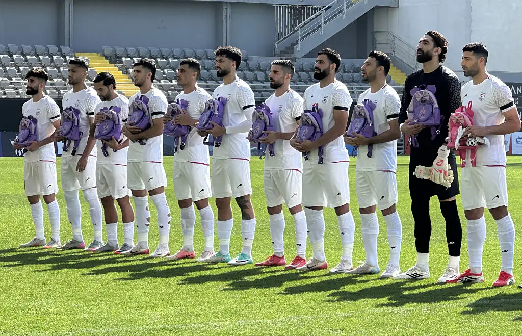 The Iranian National Team players holding backpacks in memory of the people killed in the strike (Stringer/Anadolu via Getty Images)