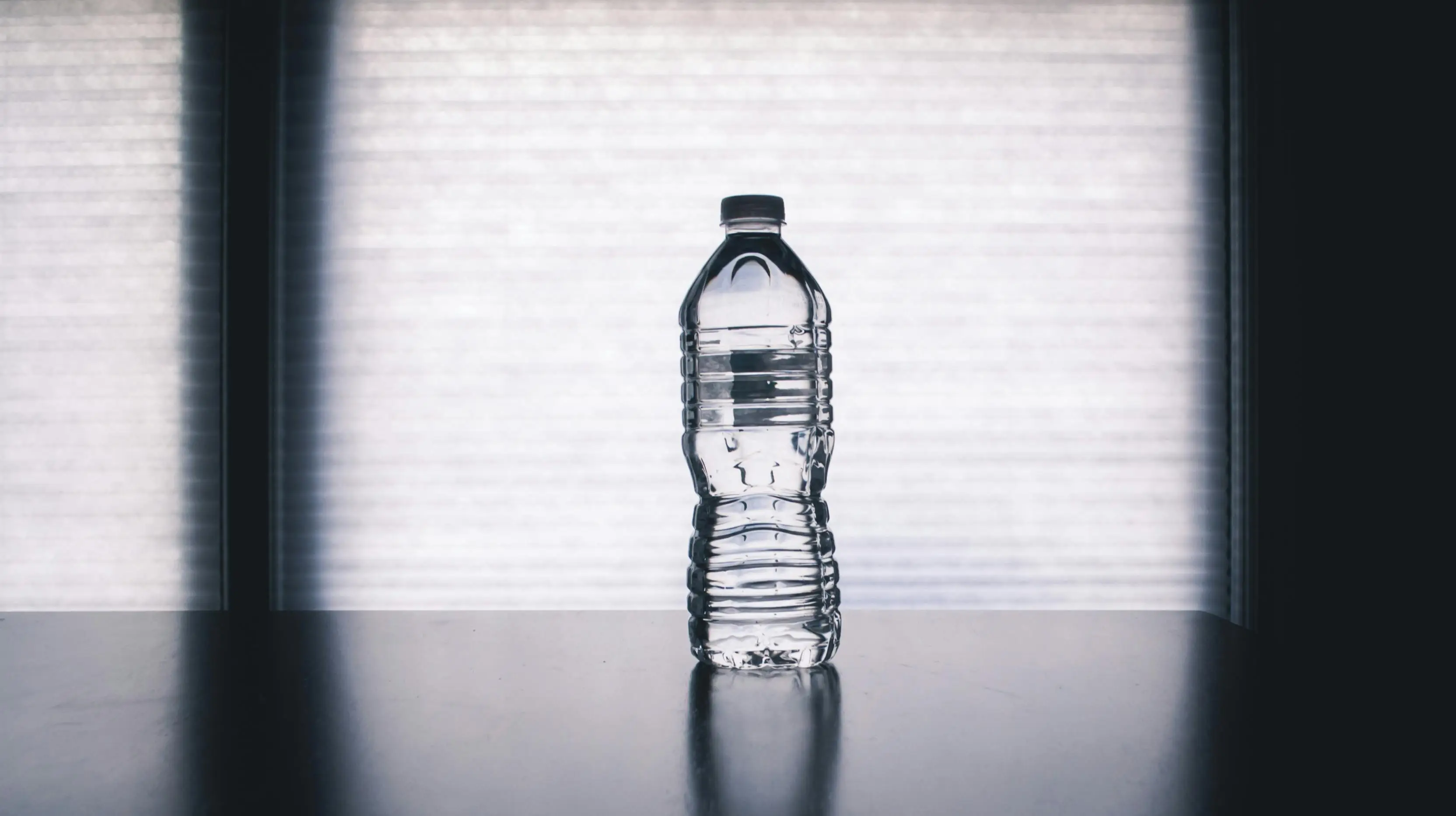 A water bottle rolled under the bed can show if someone is hiding underneath or not. (Pexels)