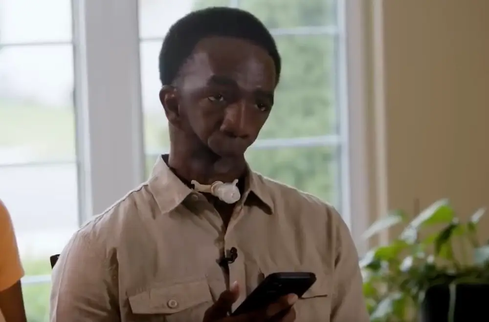 Joseph Williams types onto his phone as a way of communicating.