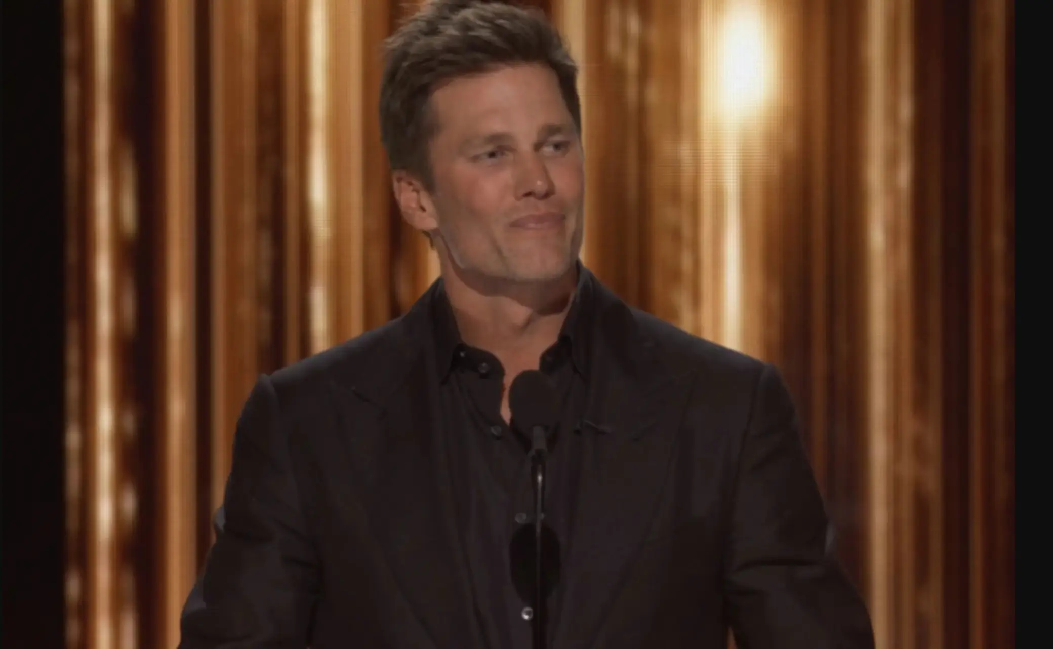 Tom Brady roasted Kim's ex-husband, Kanye West, during the event. (Netflix)