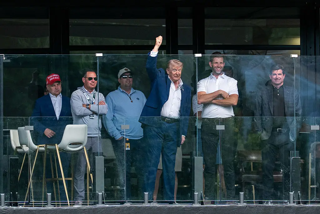 A lip reader has analysed Trump's conversation with his son Eric during a recent outing (AARON SCHWARTZ/Getty Images)