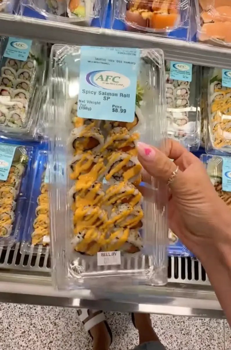 She picked up some sushi while shopping for the weekly groceries.