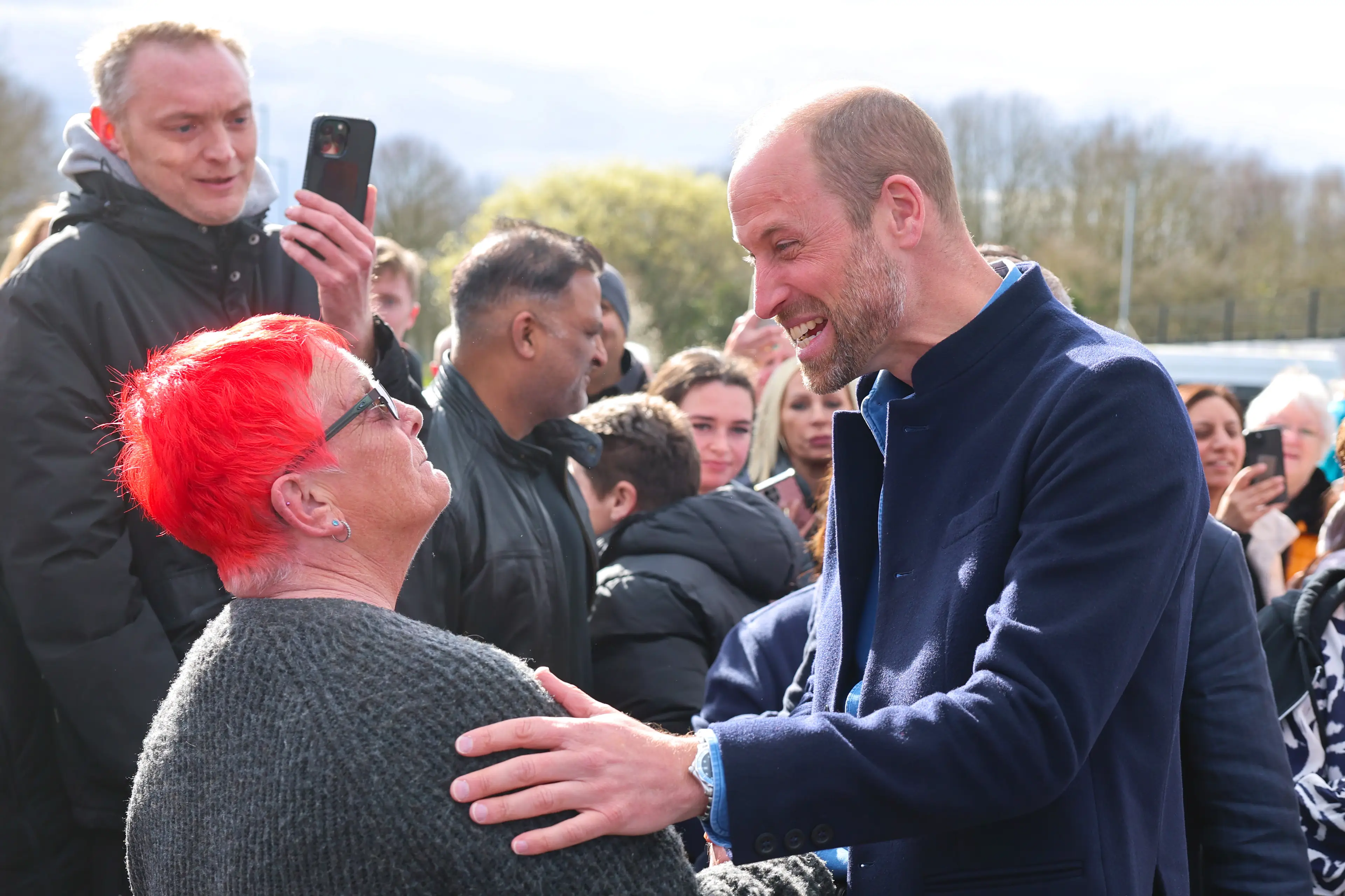 The woman's bright red 'do clearly caught the attention of the royal (PA)