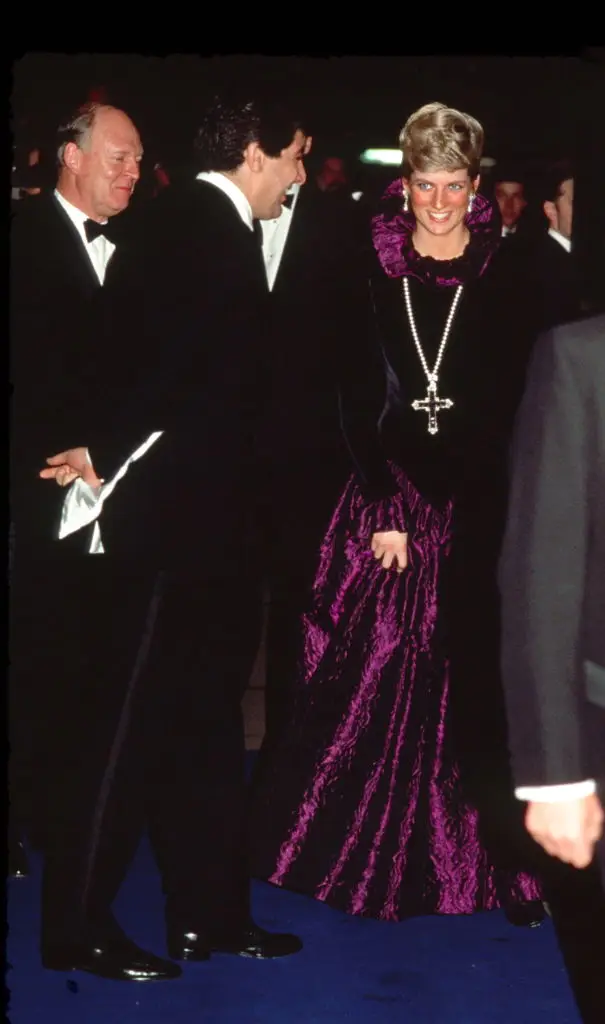 Princess Diana wore a purple evening dress with a gold and amethyst crucifix suspended on a pearl rope (Tim Graham Photo Library via Getty Images)