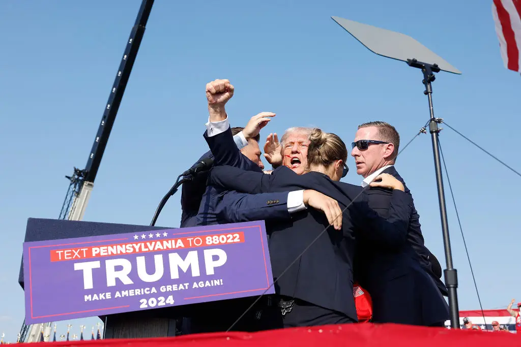 Trump defiantly didn't take cover after being shot and instead rose his fist in the air (Anna Moneymaker / Staff / Getty Images)