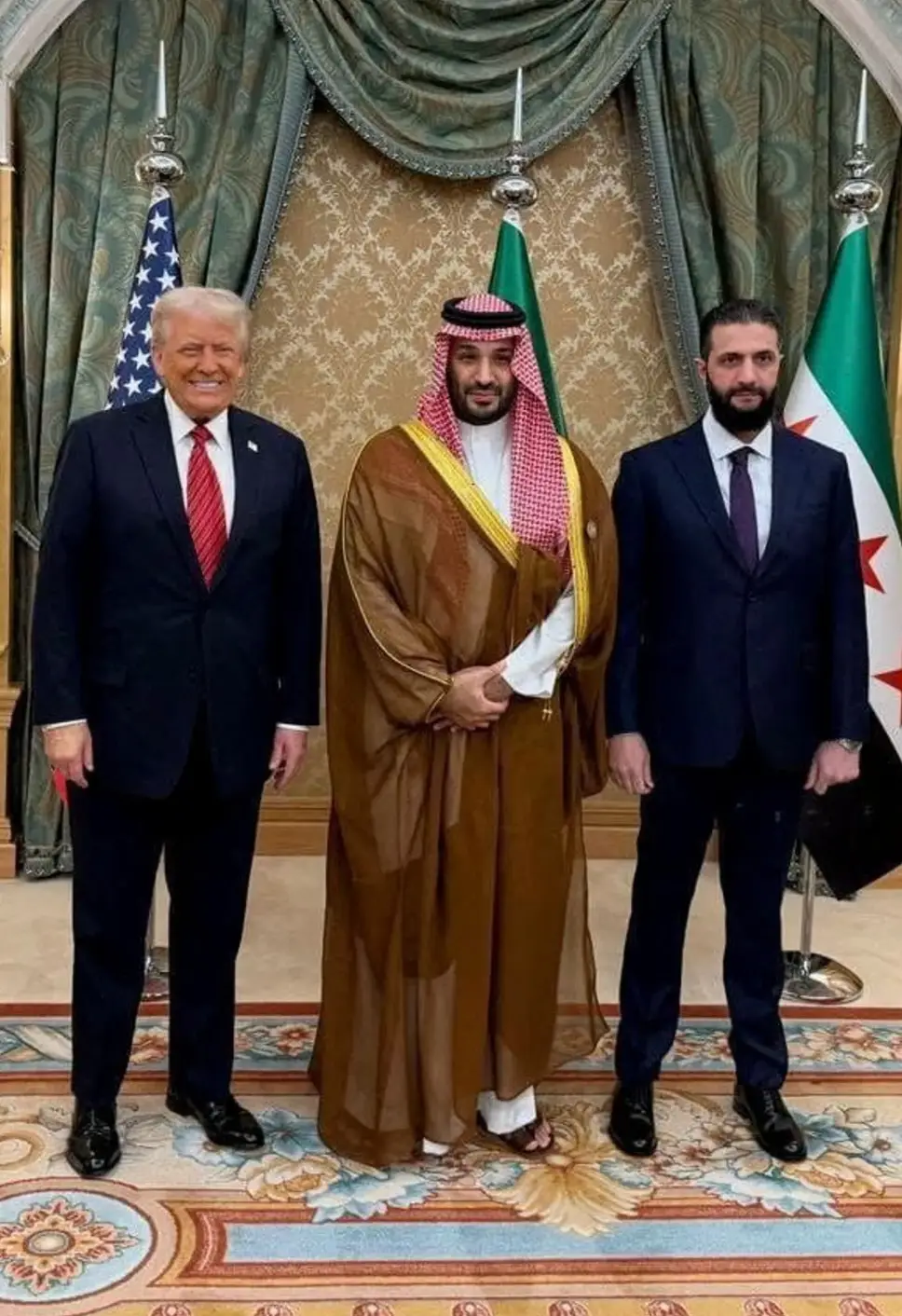 Trump posing alongside Saudi Crown Prince Mohammed Bin Salman (centre) and Syrian President Ahmed al-Sharaa in May of this year (Saudi Press Agency)