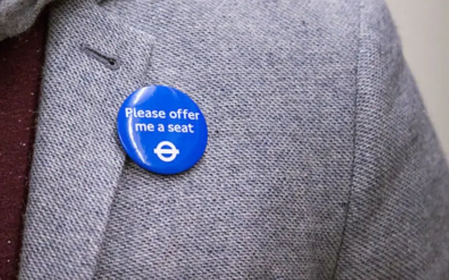 Some public transport operators offer badges for people who need seats even if it isn't immediately obvious.