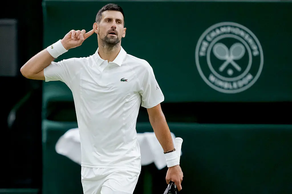 He took off the blazer to play the match (BSR Agency/Getty Images)