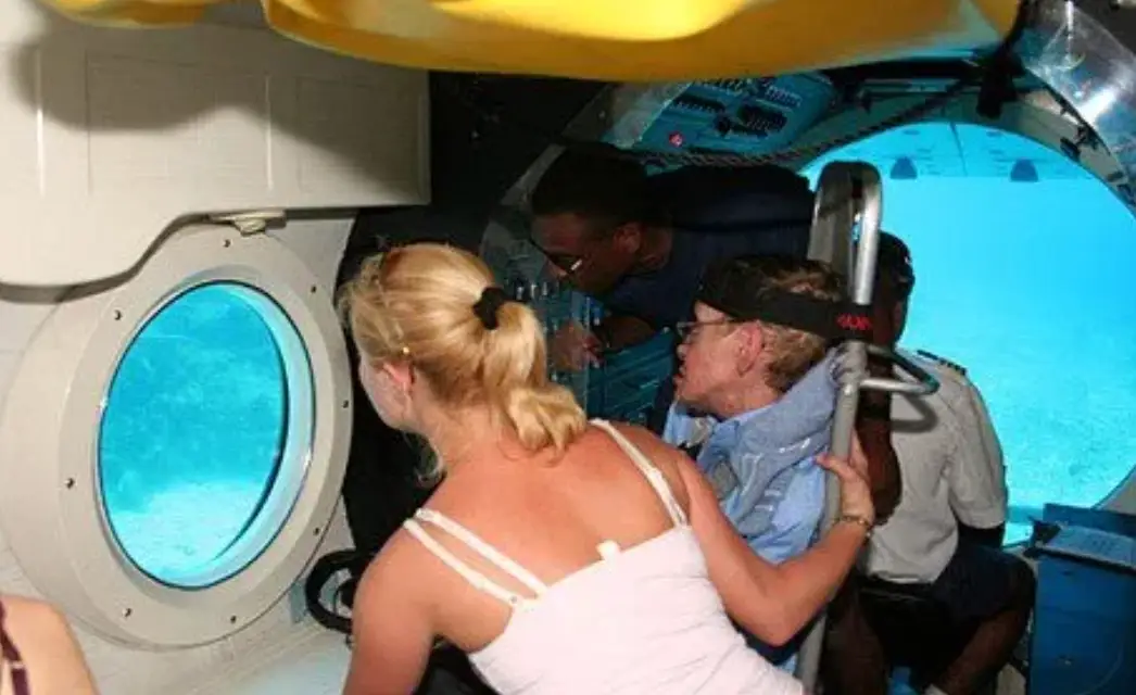 Hawking is seen in a submarine with a blonde woman in one photo (Department of Justice)