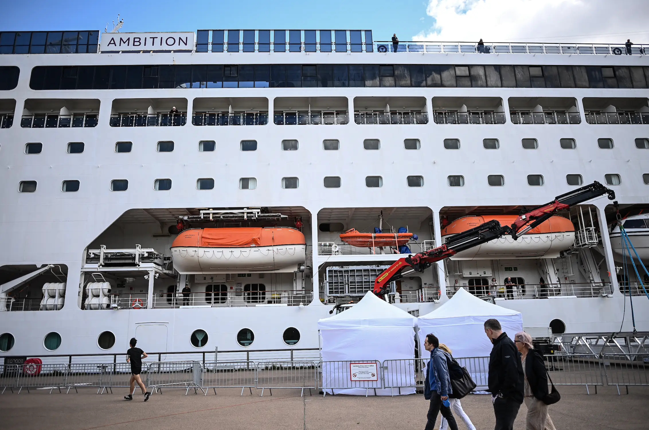 Healthy passengers were permitted to disembark (Christophe ARCHAMBAULT / AFP via Getty Images)