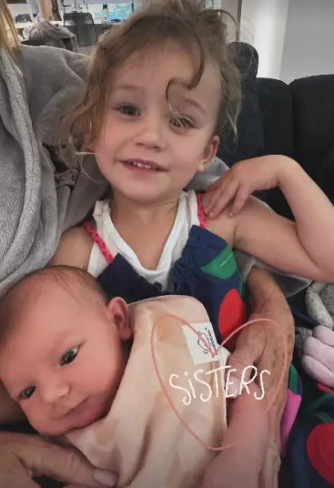 Another family photo showed sisters Matilda and Philomena cuddling (@kaleycuoco/Instagram)