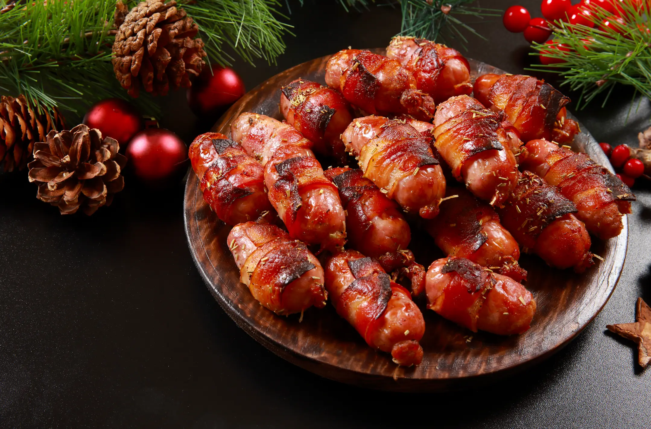 What's not to love about sausages wrapped in bacon? (SGAPhoto/Getty Images)