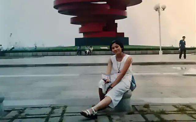 Xue took a picture in front of the sculpture in May Fourth Square (ChannelNewsAsia)