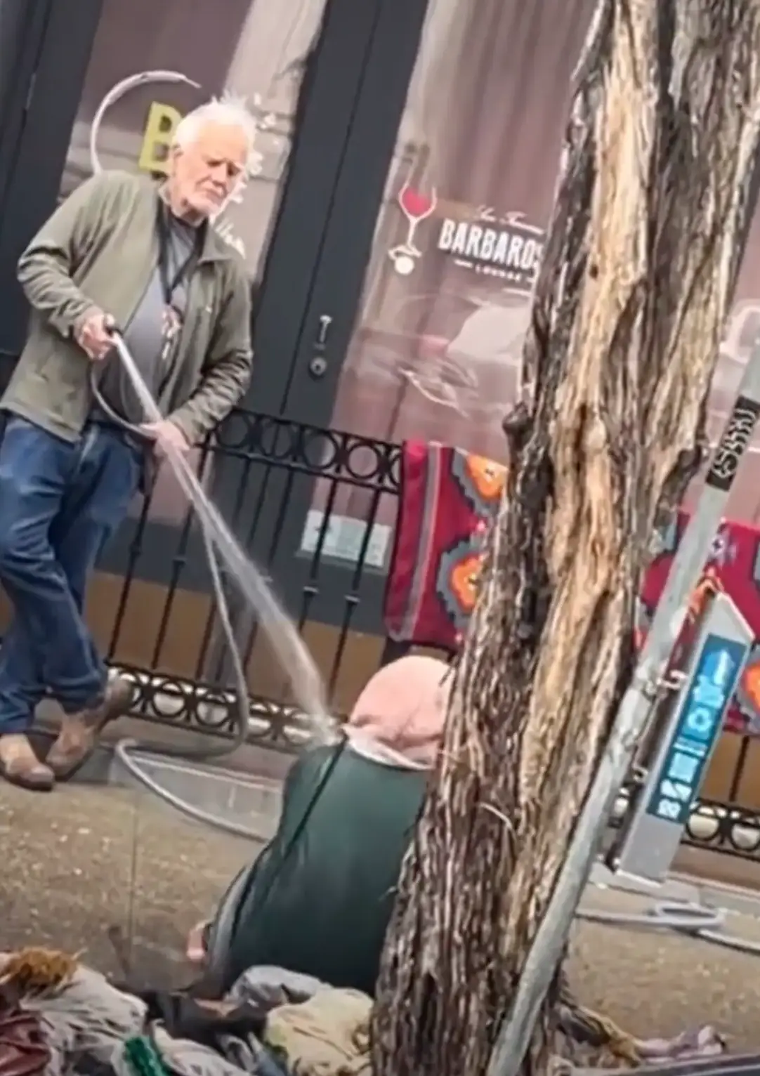 Collier Gwin was filmed hosing down a homeless woman with water.