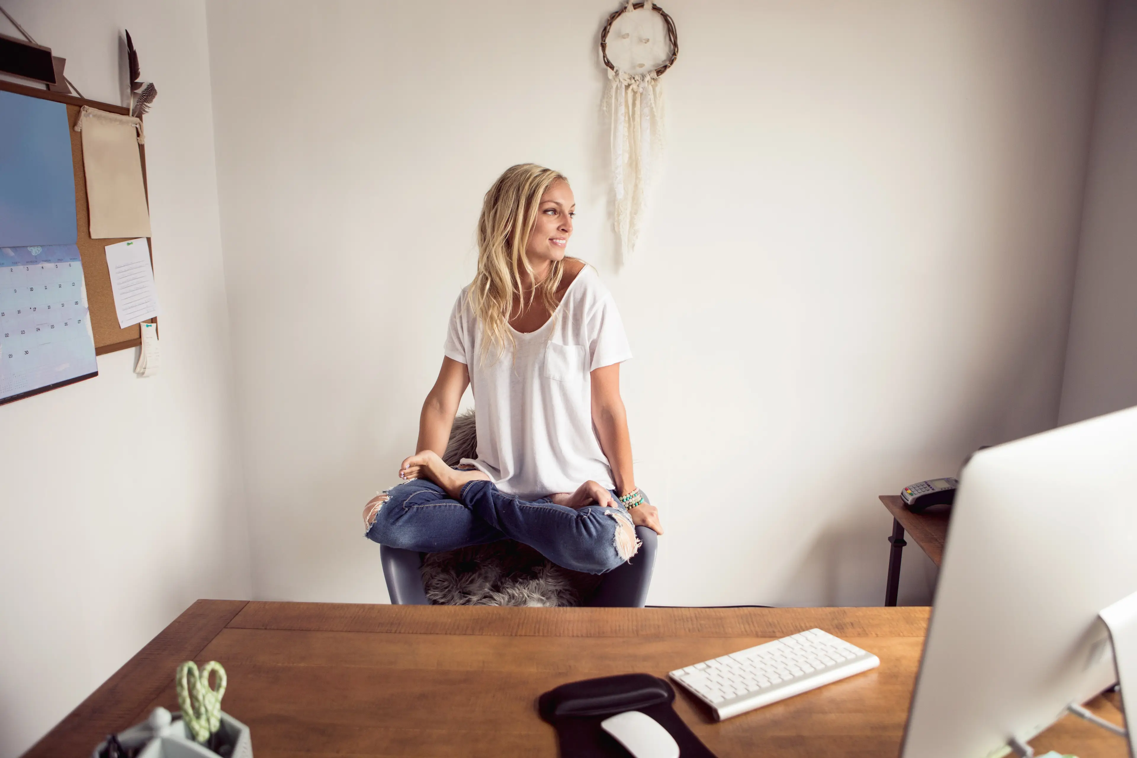 According to research, people with ADHD sometimes 'perch' on seats while they work, or tuck their feet under their bodies for comfort (Getty Stock Image)