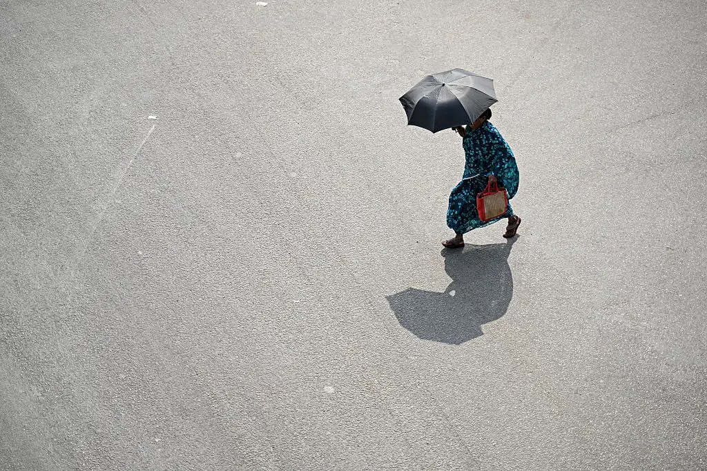A pedestrian shielding from the heat in Chennai, India, this week (R. Satish BABU / AFP via Getty Images)
