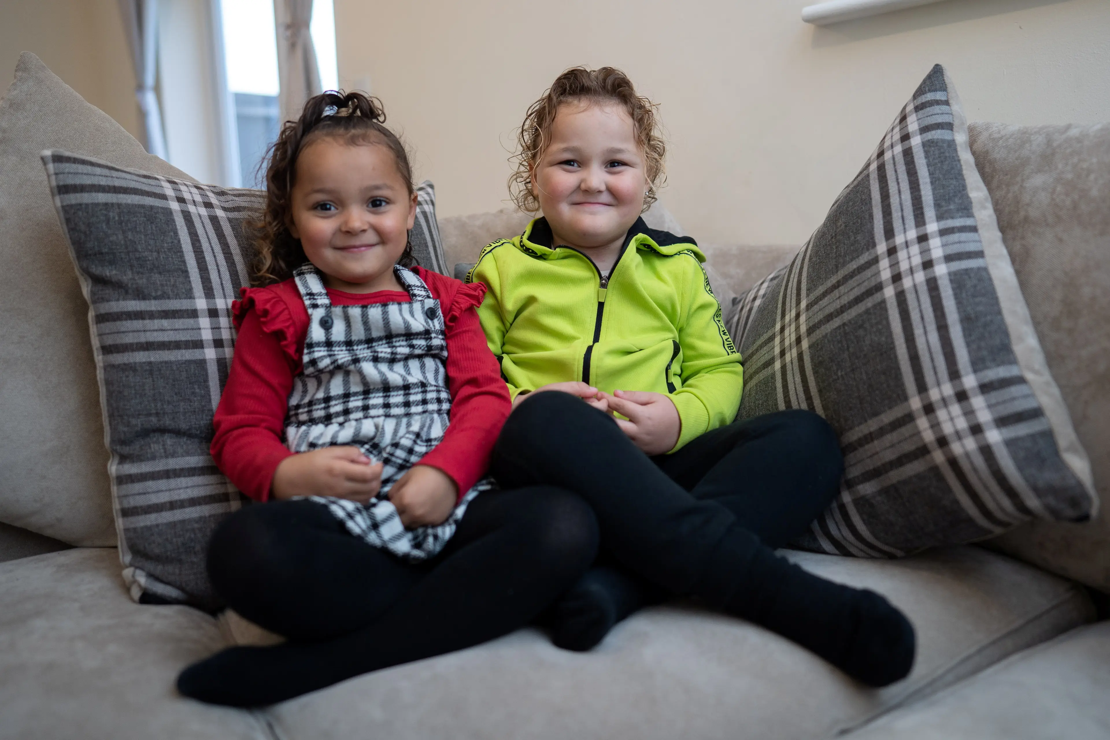 The twins have noticeably different skin colours.