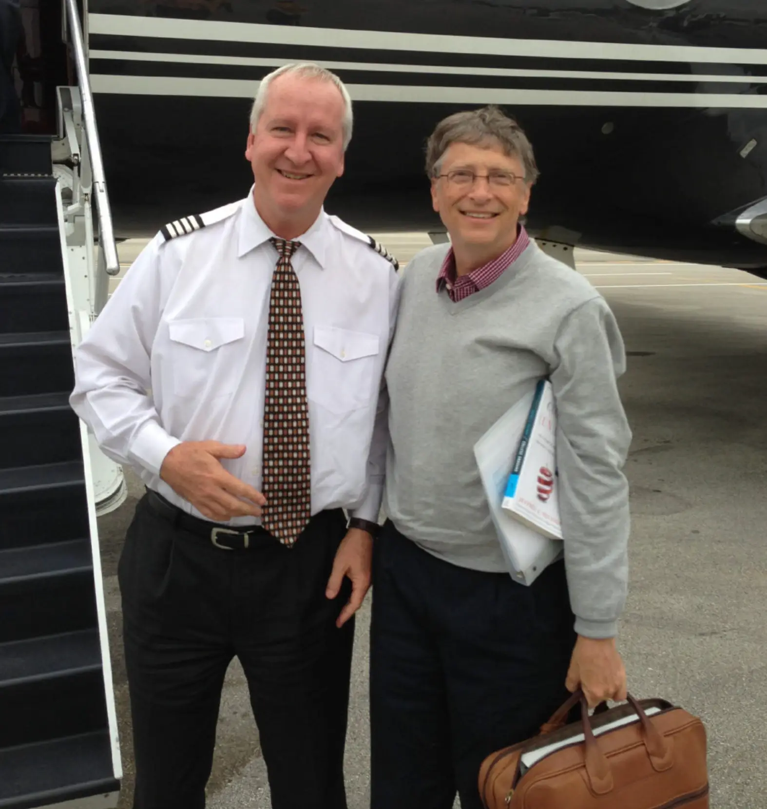 In another image, Bill Gates poses with a pilot near the steps of a private plane (House Oversight Committee)