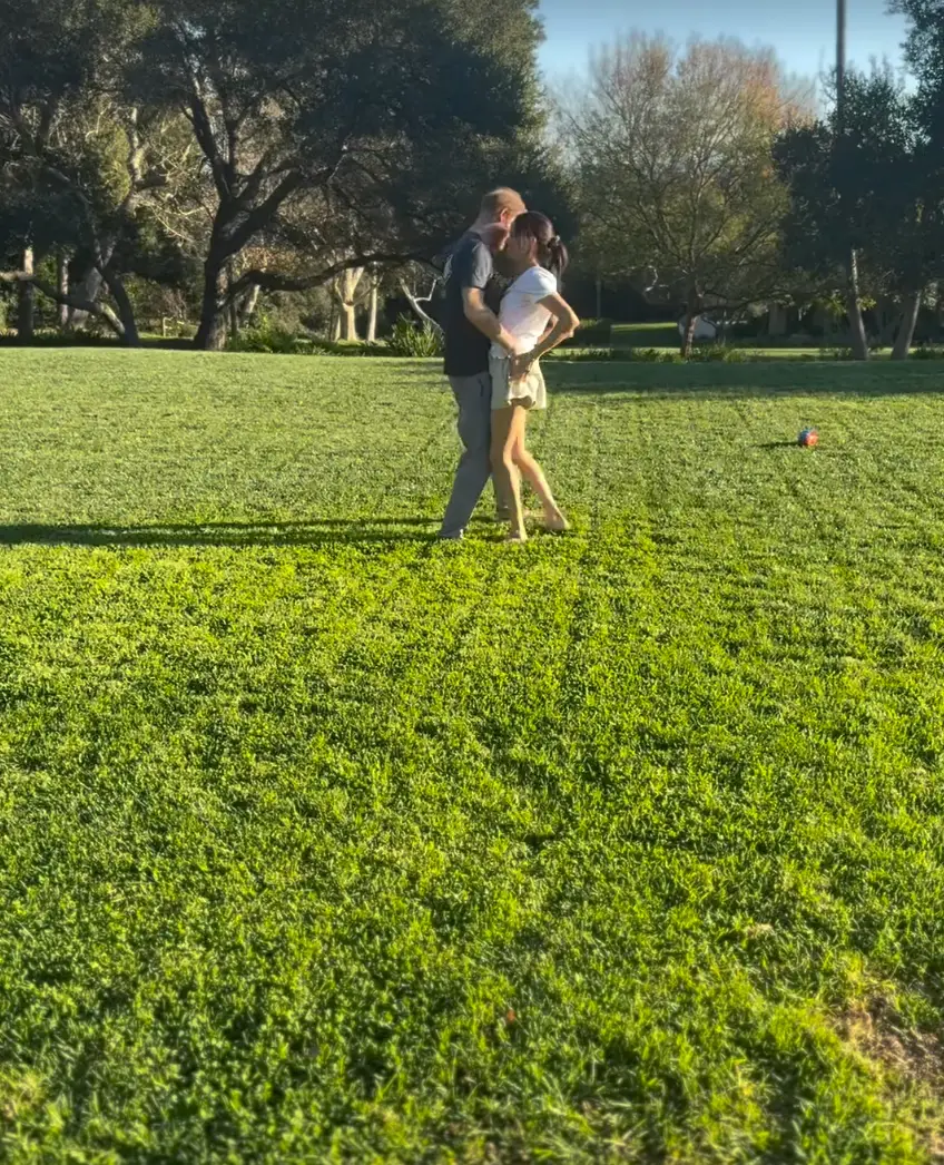 Harry can be seen grabbing his wife's behind (Instagram/@meghan)