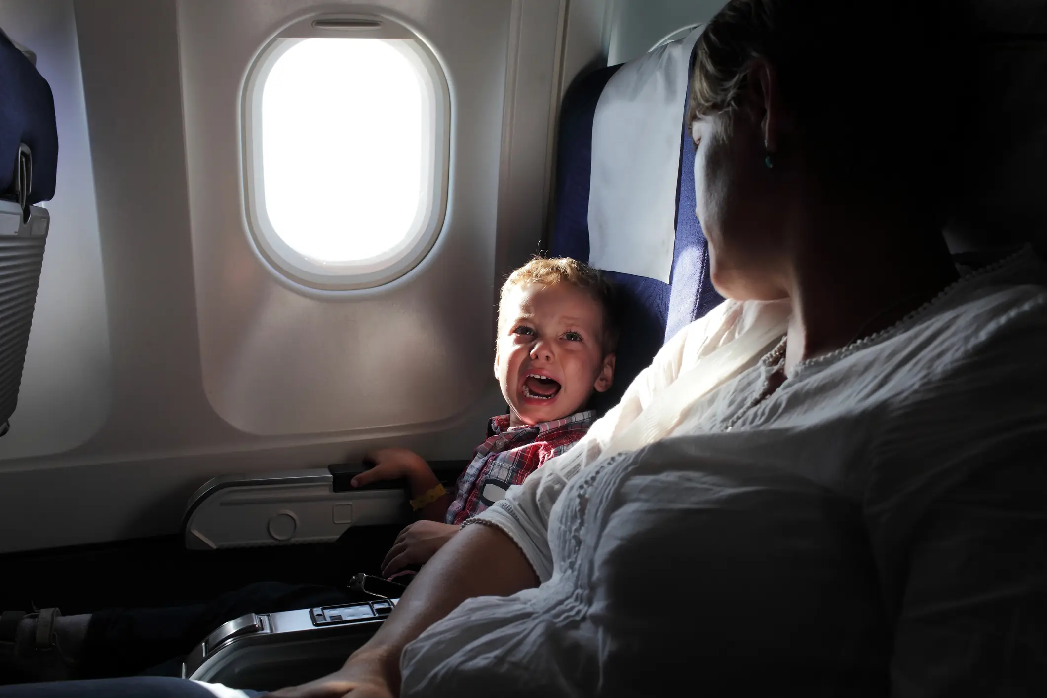 Sitting next to crying kids on a plane, we've all been there (Getty Stock Image)