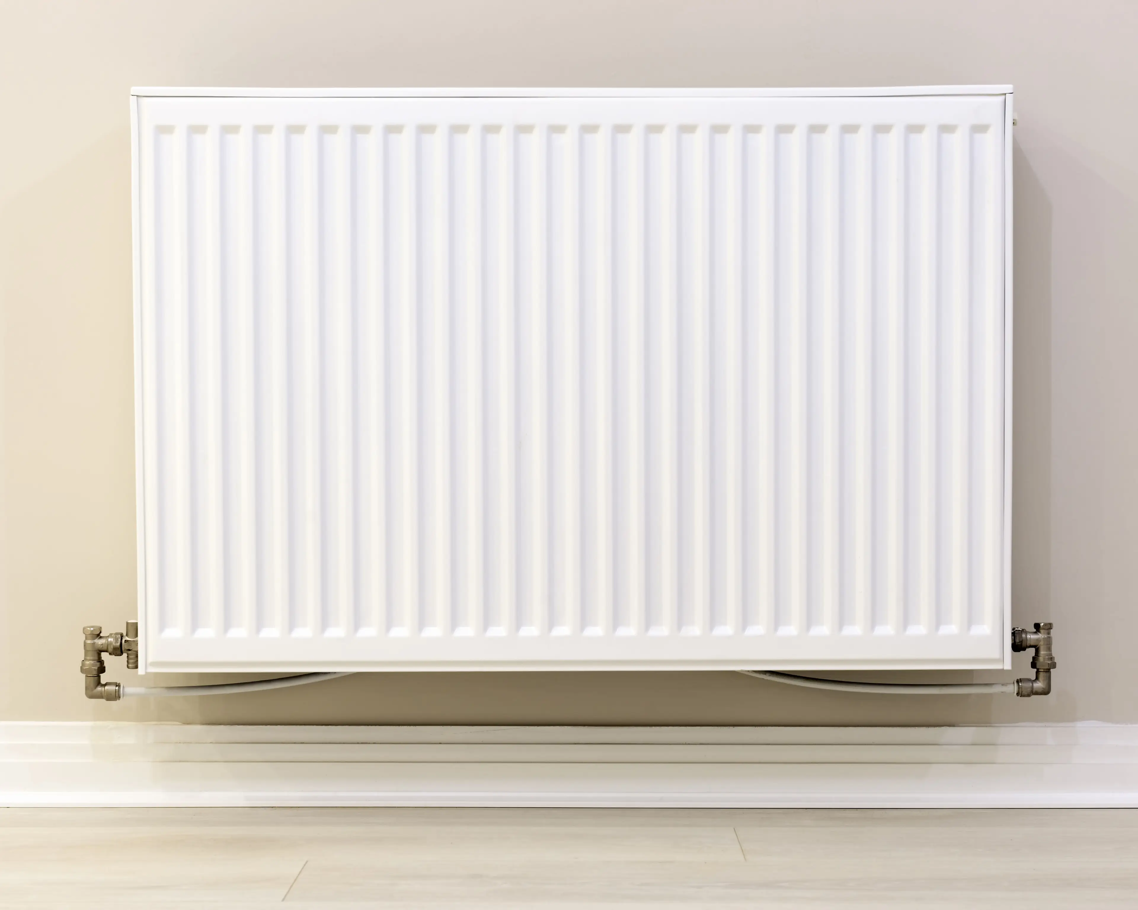 The woman put her clothes airer next to the radiator.