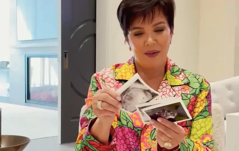 In the 90 second clip, Stormi hands Kris an envelope filled with scan photos (