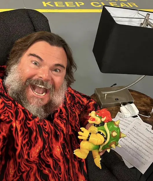 Jack Black holding a Bowser action figure.