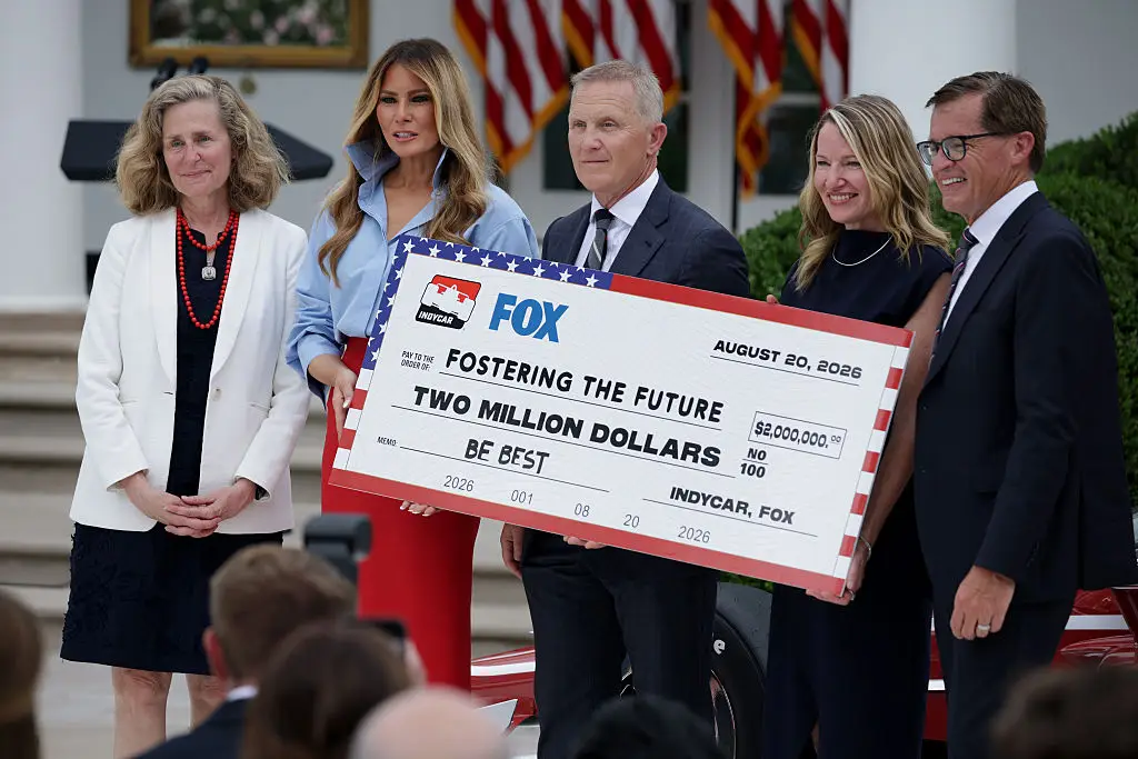 L-R) Indiana University President Pamela Whitten, first lady Melania Trump, Fox Sports CEO Eric Shanks, Purdue University Vice Provost for Enrollment Cherise Hall, and IndyCar President Doug Boles pose with a check during an event announcing the expansion of a foster care initiative. (Photo by Alex Wong/Getty Images)