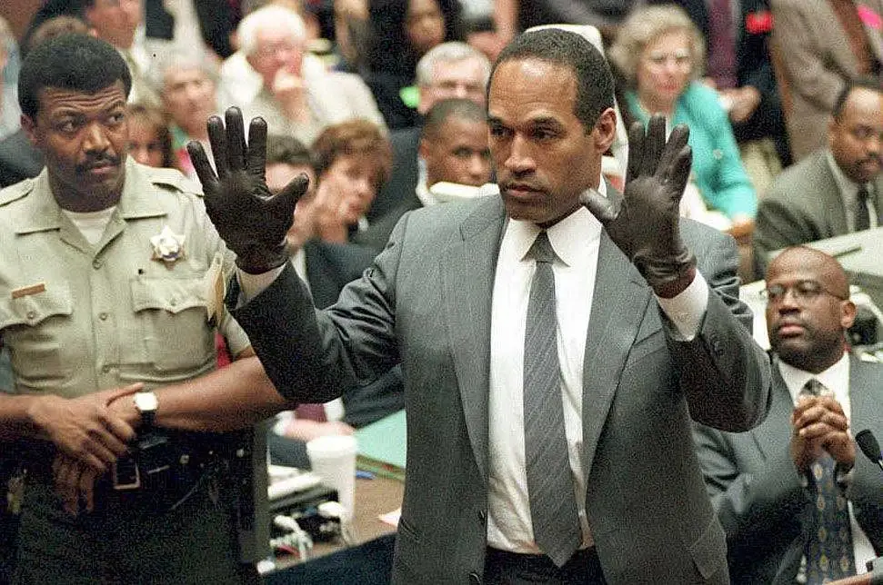 OJ Simpson shows the jury a new pair of Aris extra-large gloves, similar to the gloves found at the crime scene, during his double murder trial in Los Angeles (VINCE BUCCI/AFP via Getty Images)