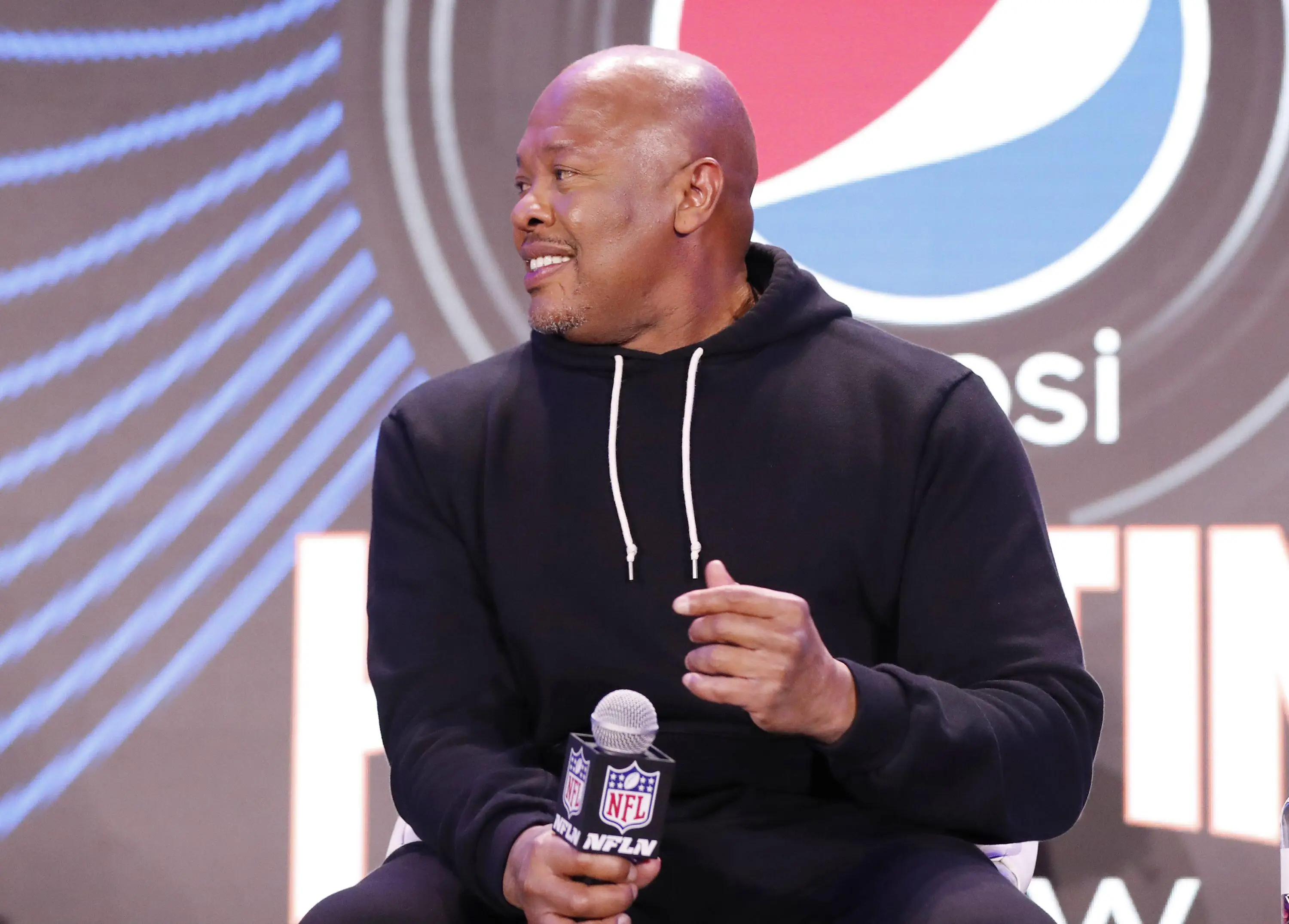 Dr Dre sits down for Super Bowl halftime show press conference. (Alamy)